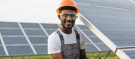 Image of a man standing in front of solar panels