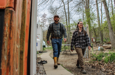 Matt and Maria S. walk together on their goat farm.