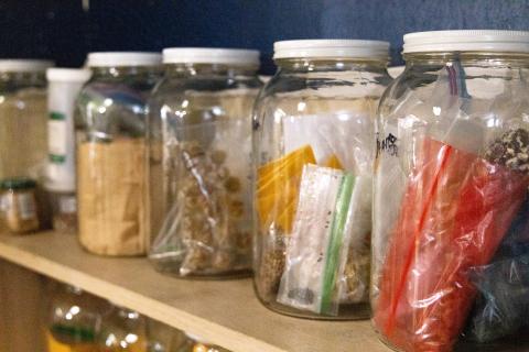 Jars of seeds sitting on shelf