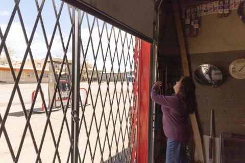 A woman opens a garage bay door