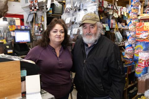 a woman and man stand next to each other for a photo