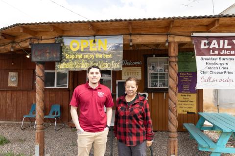 Man and woman stand outside a restaurant 