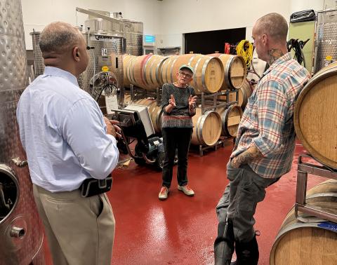 Perry Hickman, Sally Cowal and Joshua Riesner in the winemaking area of Muse Vineyards