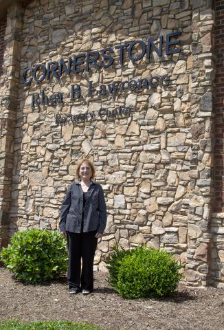 Sandy Bryant in front of the Rhea B. Lawrence Recovery Center