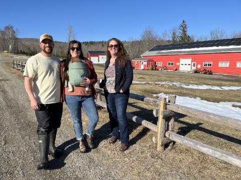 Molly and Jess of Piper Mountain Christmas Tree Farm stand in front of their barn with USDA Rural Development State Director Rhiannon Hampson.
