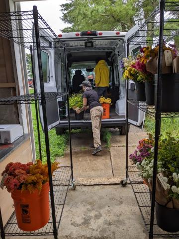 Delivery drivers Luis Santana and Gina Bartholomew unloading flowers at the Hub Photo taken by Sofia Oliver