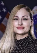 photo of woman smiling in front of flags