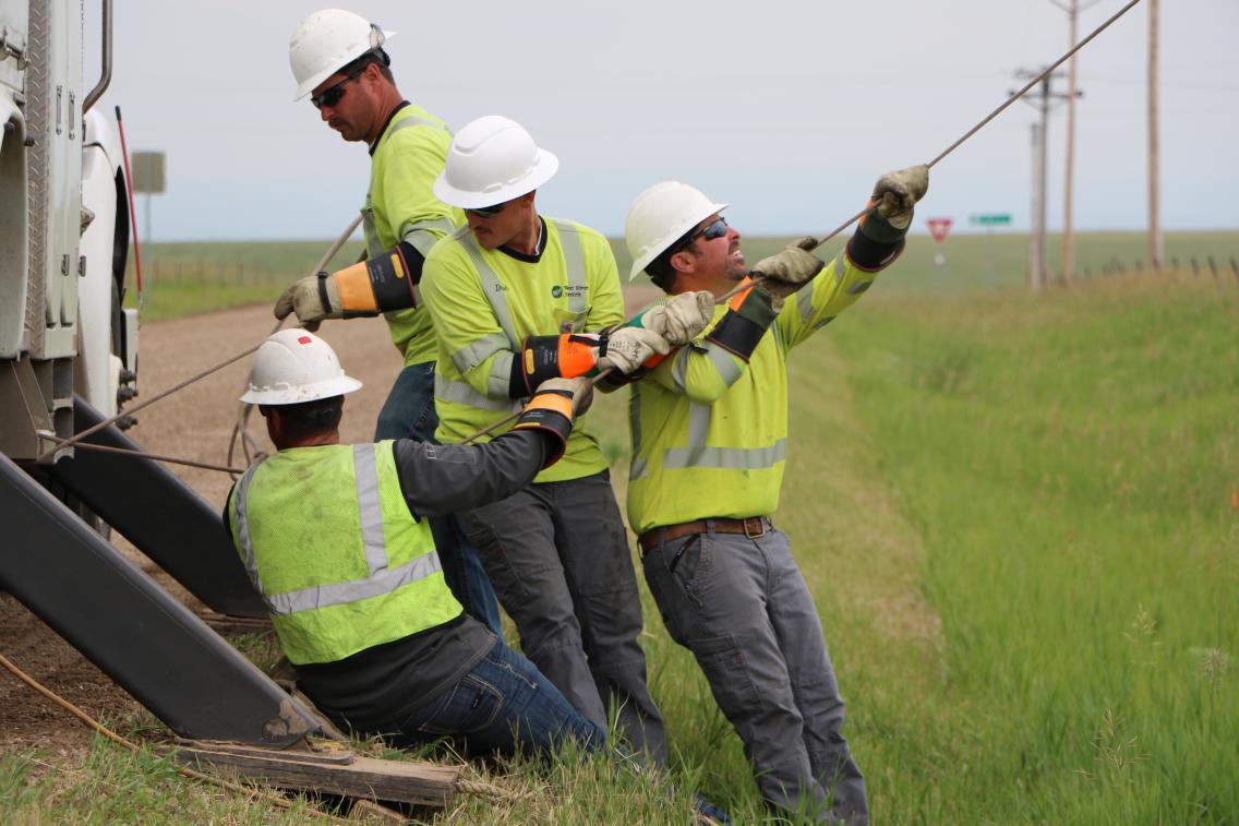 West River Electric Association crews install power lines in South Dakota