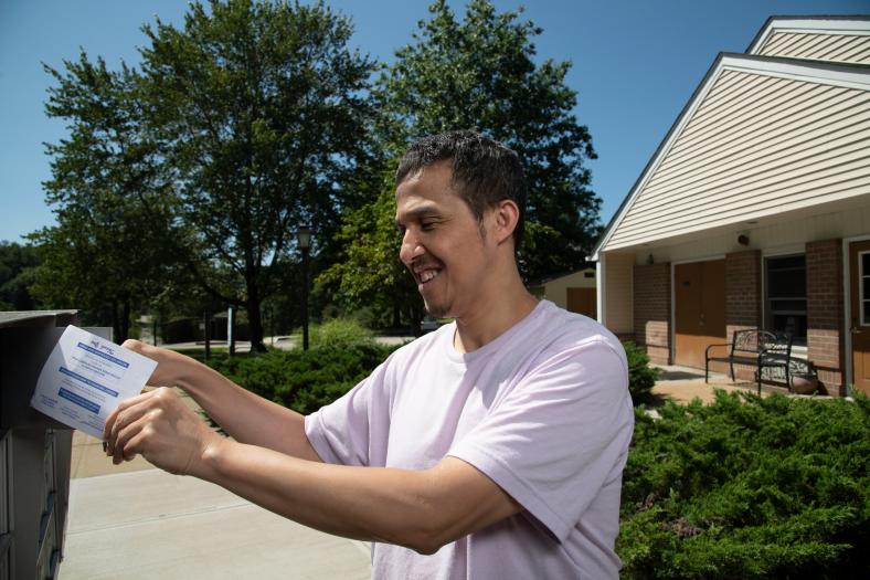 Union Valley Apartments Resident David Pham checks his mail.