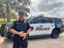 Calvert police officer displays the 2018 patrol vehicle purchased with USDA Rural Development funds