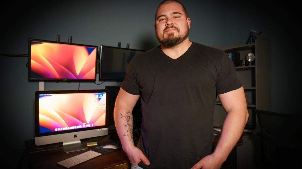 Ryan Tanney, a worship pastor at a church in Pine Grove, California, stands in front of several screens, which are used to manage a live broadcast of Sunday services.