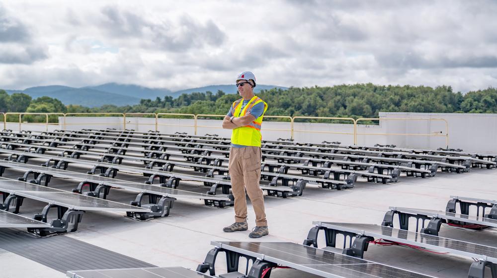 Owner Brett Hayes surveys newly installed solar panels on the roof of the Zeus Digital Theater.