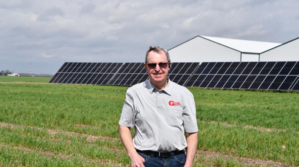 Doug Goyings stands in front of the solar array that is cutting energy costs on his family grain farm in NW Ohio.