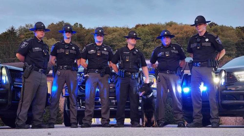 A picture of Barbour County Deputy Sheriff's wearing their new body cameras and standing in front of their new cruisers.