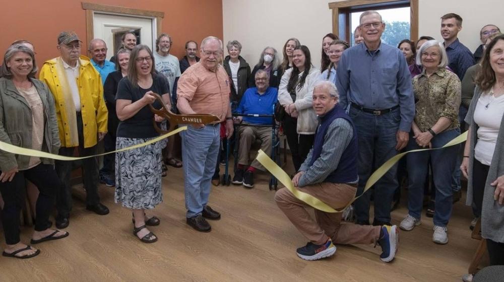 A group of staff and volunteers pose for a photo during the grand opening celebration of The BRICK food bank.  