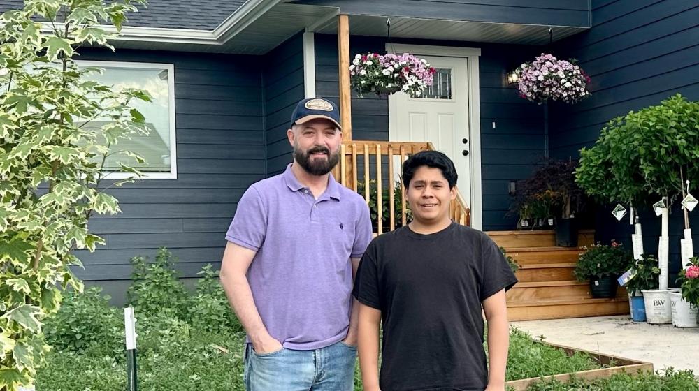 Joe Barb and his son outside their home in Rapid Valley