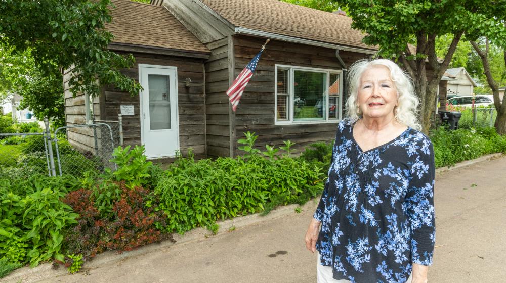 Jolene stands outside her home.