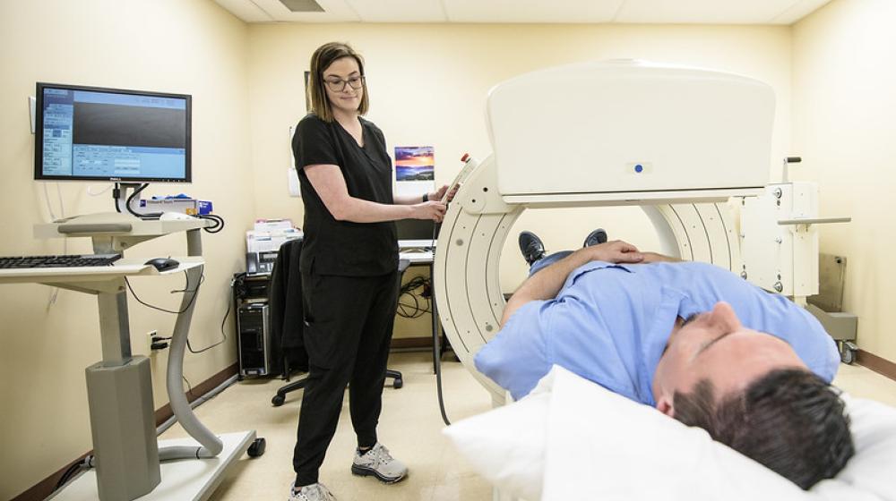 Photo of nurse using a nuclear medicine camera