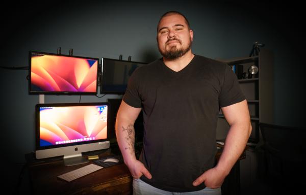 Ryan Tanney, a worship pastor at a church in Pine Grove, California, stands in front of several screens, which are used to manage a live broadcast of Sunday services.