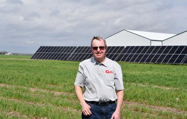 Doug Goyings stands in front of the solar array that is cutting energy costs on his family grain farm in NW Ohio.