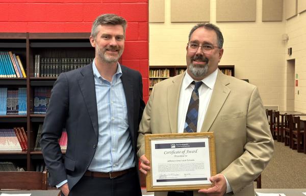 Ohio state director presents certificate to Jefferson Local School District Superintendent. 