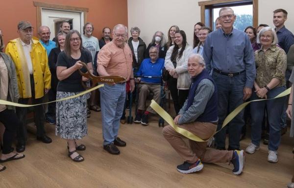 A group of staff and volunteers pose for a photo during the grand opening celebration of The BRICK food bank.  