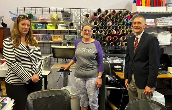 Stephanie Duffy, Jennifer Ledford, and George Reed in the Initial Inspiration work area to Stephanie Duffy and George Reed