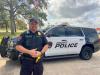 Calvert police officer displays the 2018 patrol vehicle purchased with USDA Rural Development funds