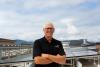 Bruce Hanna, owner of Hampton Inn and Suites Roseburg, visits solar panels recently installed on hotel roof.